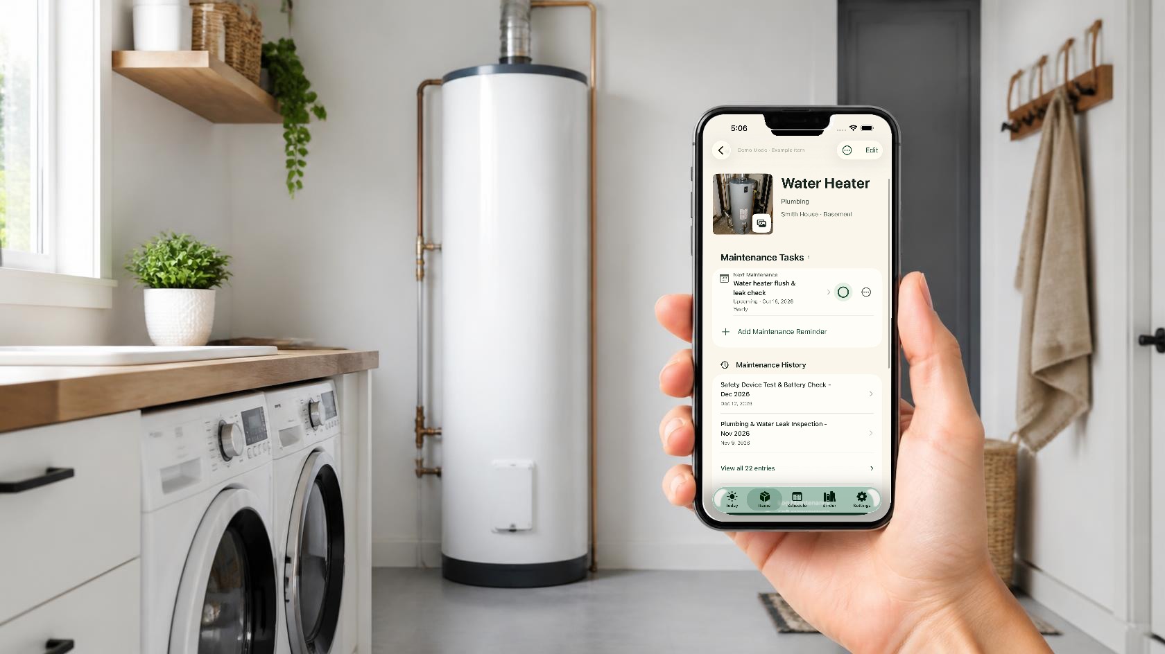 A hand holding an iPhone with the real Around The House water heater record open in a laundry room beside the heater.